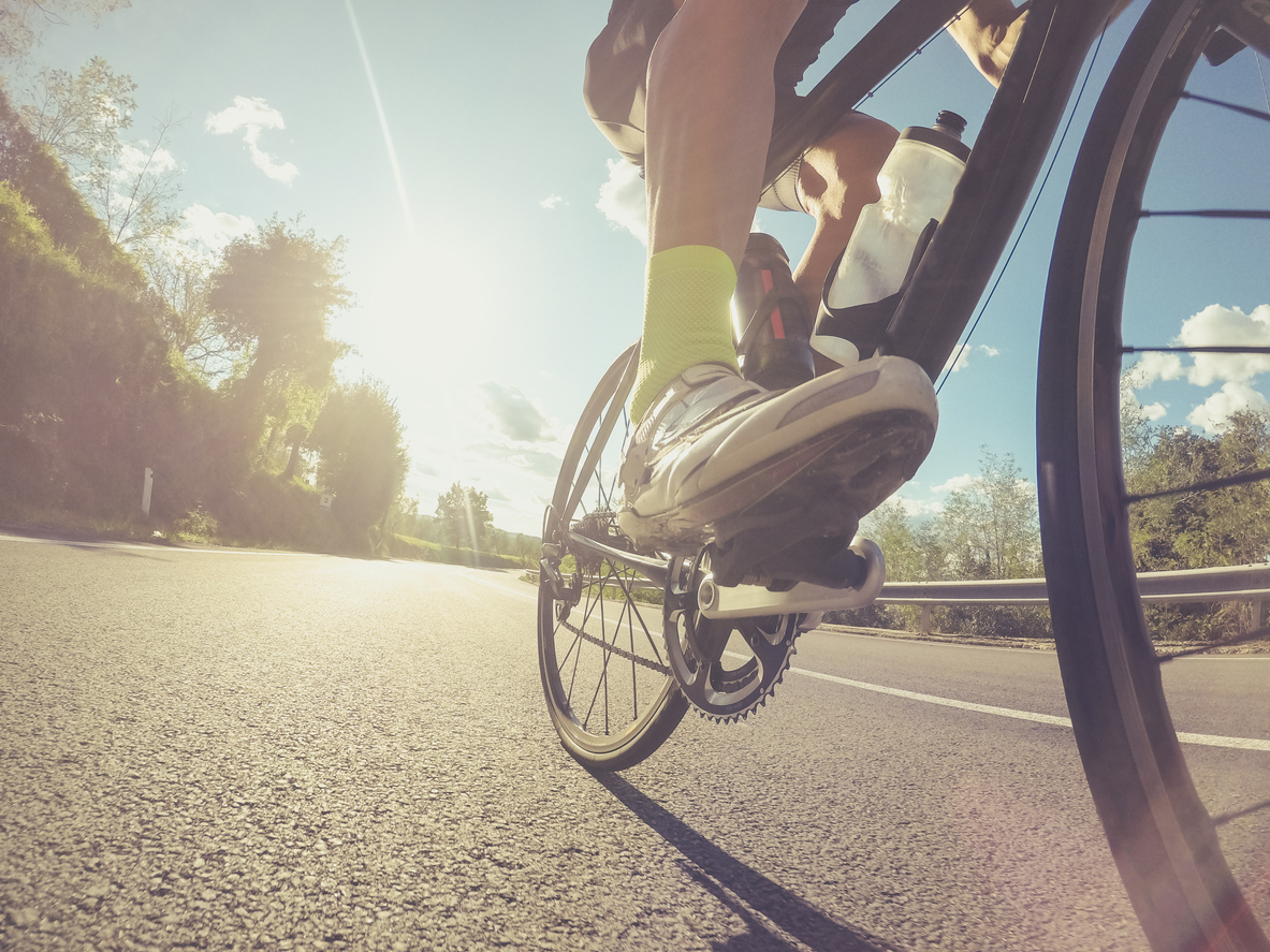 Unusual low angle view of an athlete riding a bicycle